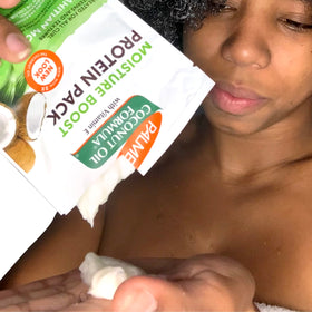Palmer's Coconut Hair Care products with fresh coconuts