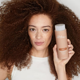 Paul Mitchell Color Protect Shampoo in a bathroom setting