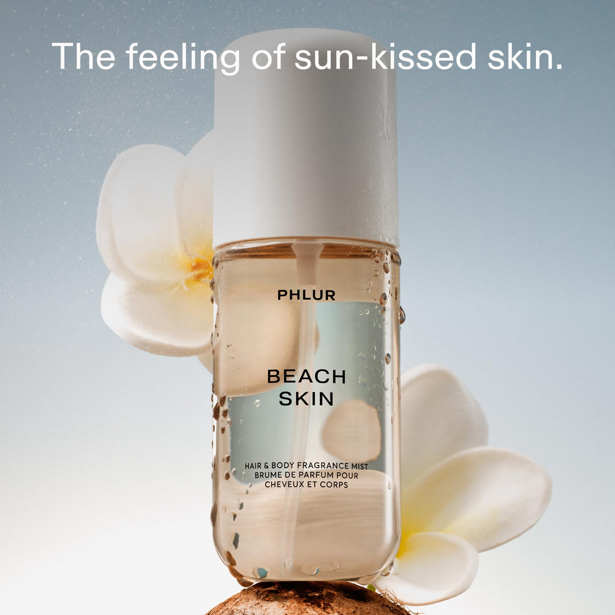PHLUR Beach Skin Body Mist bottle with floral background
