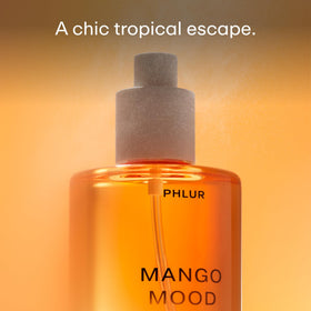 PHLUR Mango Mood Body Mist bottle with tropical background