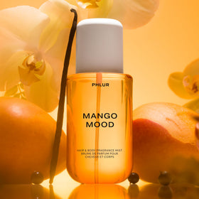 PHLUR Mango Mood Body Mist misting on skin
