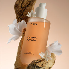 PHLUR Missing Person Body Oil 4 Oz on a bathroom counter