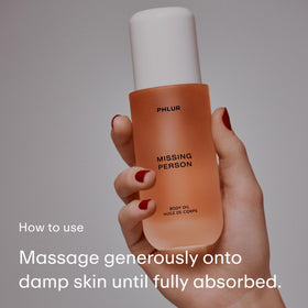 PHLUR Missing Person Body Oil 4 Oz with a dropper dispensing oil