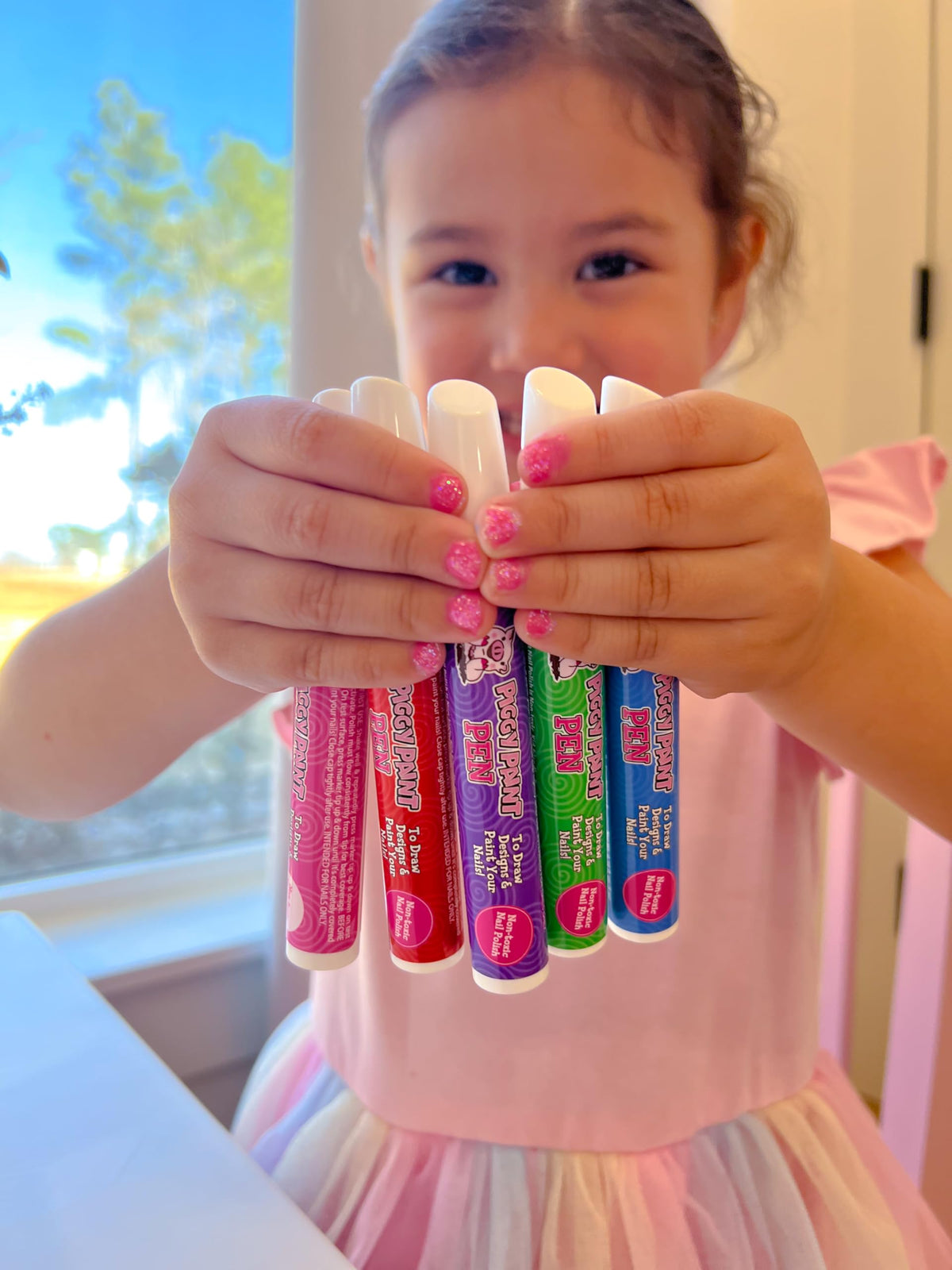 Piggy Paint Nail Polish Pens displayed with vibrant nail art