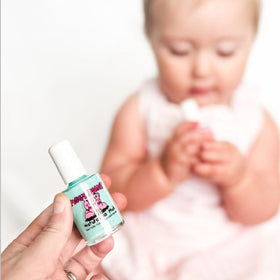 Piggy Paint Seafoam Green Nail Polish displayed with nail care tools