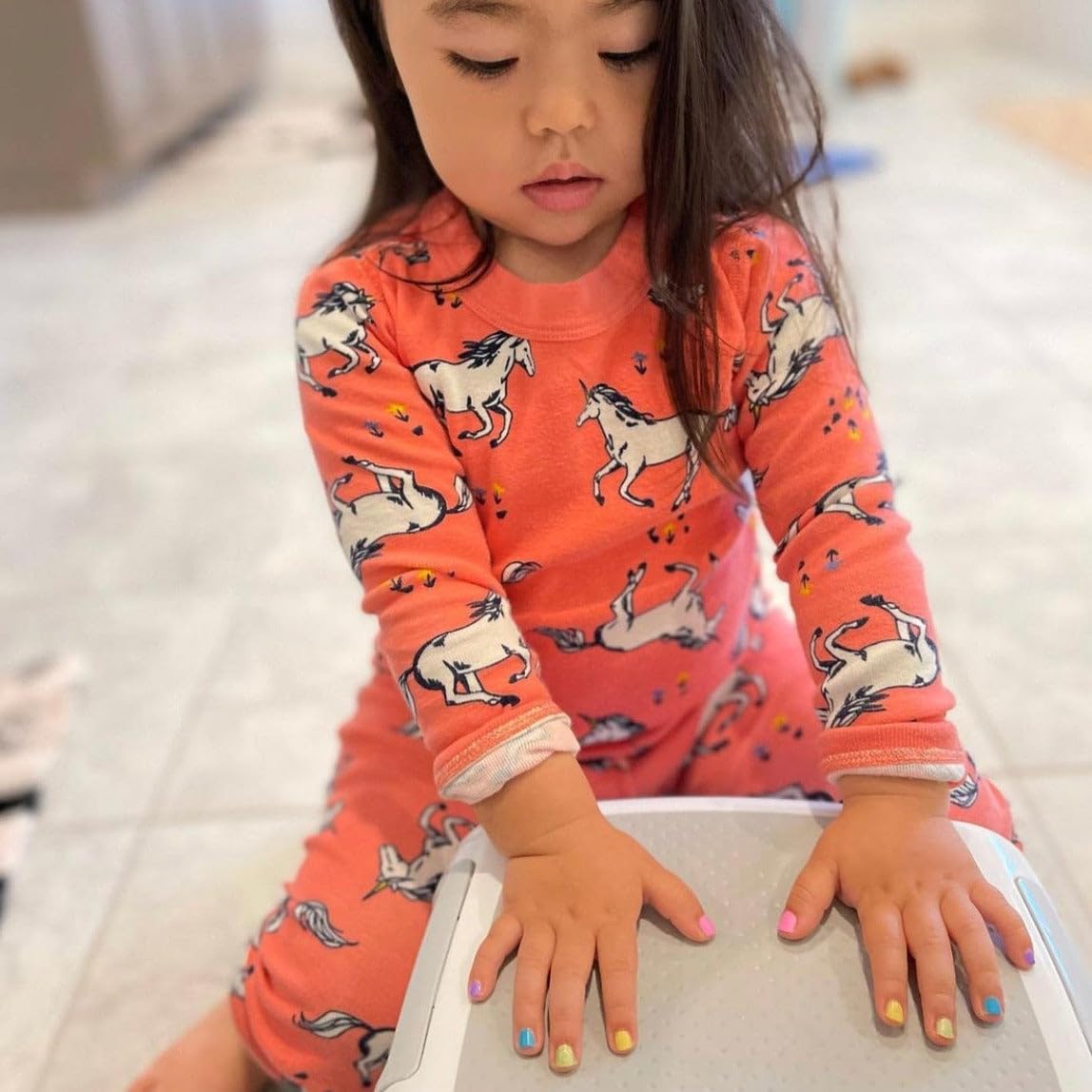 Piggy Paint Sunshine Yellow nail polish in a child's hand