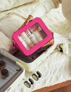 Popvibe Clear Makeup Bag on a travel setting with toiletries