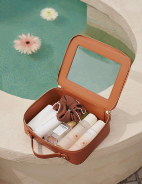 Popvibe Clear Makeup Bag on a vanity with cosmetics