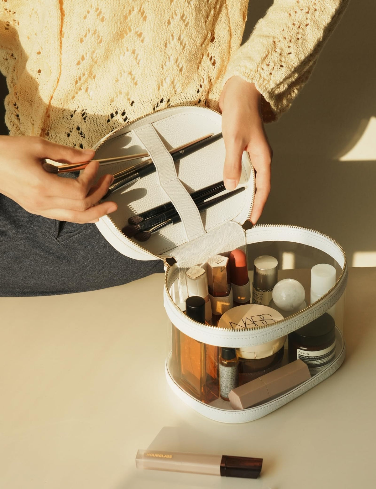 Popvibe Clear Makeup Train Case on a vanity with cosmetics