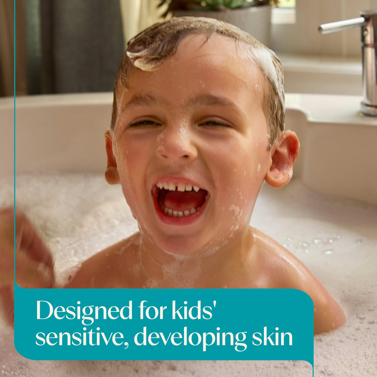 Pump bottle of Aveeno Baby Kids Face & Body Wash on a bathroom counter