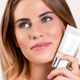 PÜR 4-in-1 Tinted Moisturizer tan shade on a vanity