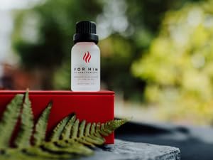 RawChemistry For Him Pheromone Infused Cologne on a wooden table