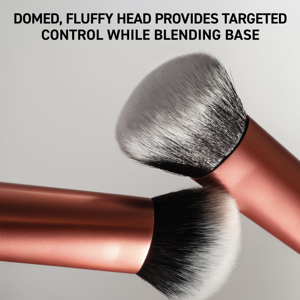 Real Techniques Expert Face Brush in hand demonstrating application