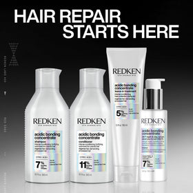 Redken Bonding Conditioner 1 Fl. Oz. on a vanity with hair tools