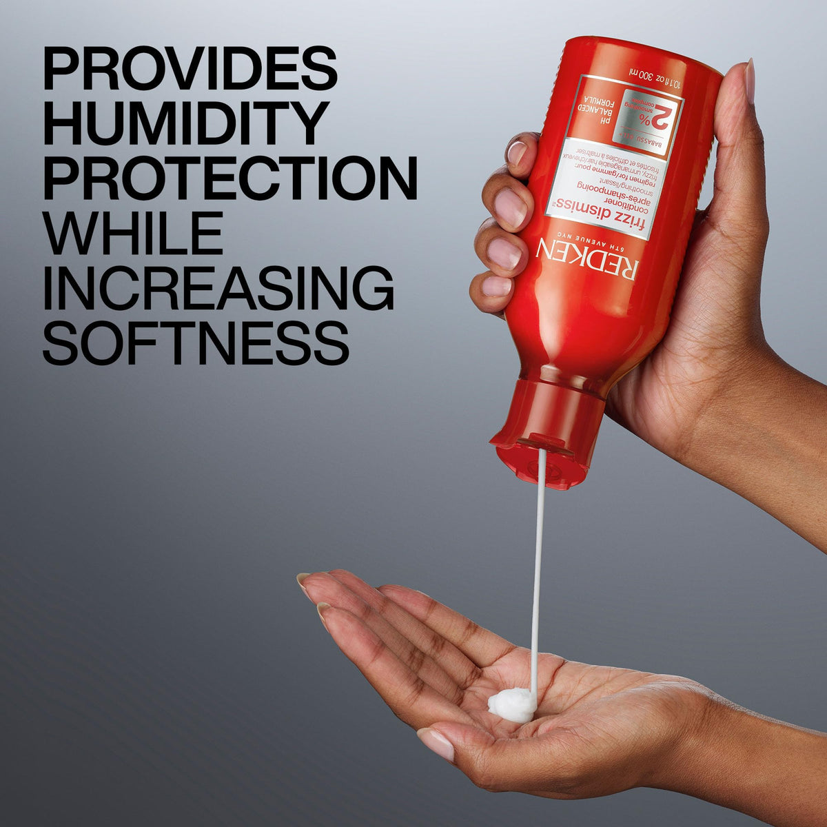 Redken Frizz Dismiss Conditioner on a bathroom shelf