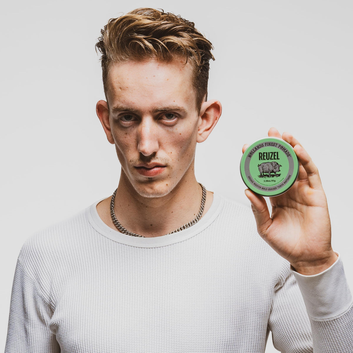 REUZEL Green Grease Pomade 110g lifestyle shot with styled hair