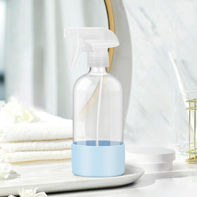 Rionisor glass spray bottle with silicone sleeve in garden