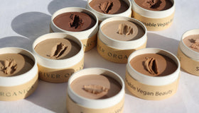 River Organics Zero-Waste Concealer on a vanity with makeup tools