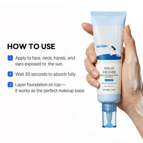 ROUND LAB Birch Juice Sun Serum on a skincare routine flat lay