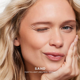 Saie Dew Bronze Liquid Bronzer Stick in Sand, lifestyle use
