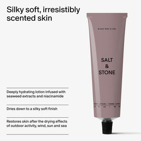 Salt & Stone Body Lotion displayed with black roses