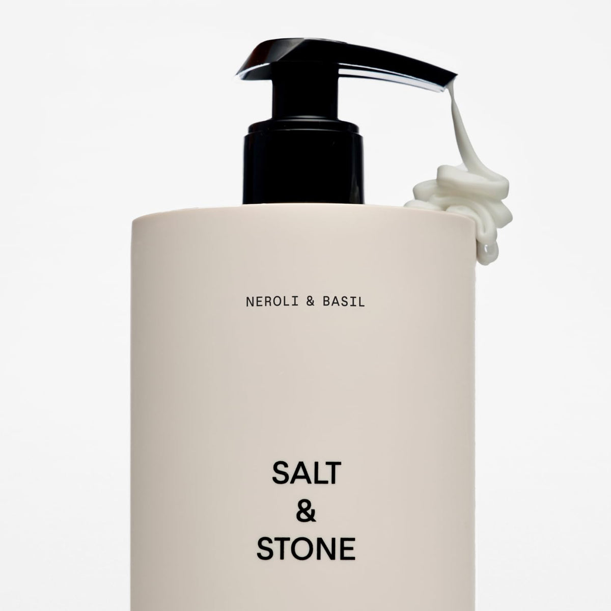 Salt & Stone Body Lotion with fresh basil leaves