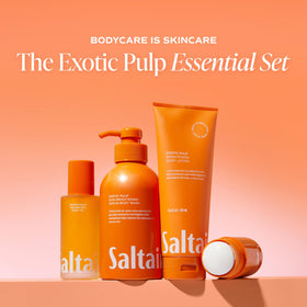 Saltair Body Oil on a wooden surface with tropical fruits