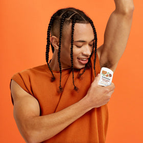 Schmidt's Sandalwood & Citrus deodorant stick with nature backdrop