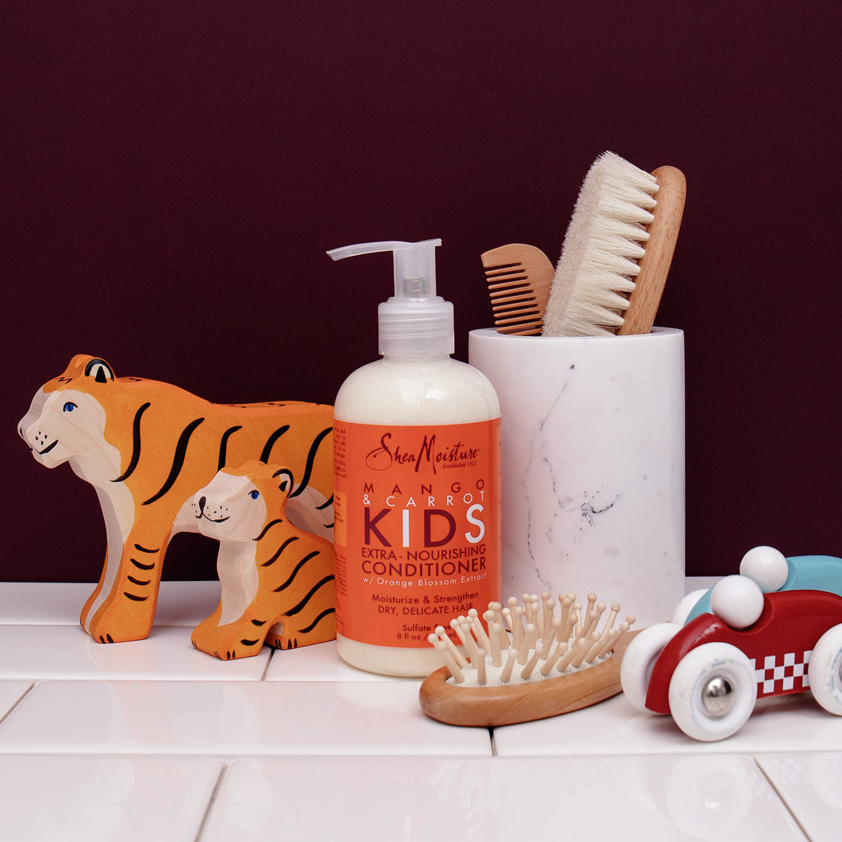 Shea Moisture Kids Conditioner Mango & Carrot on a towel