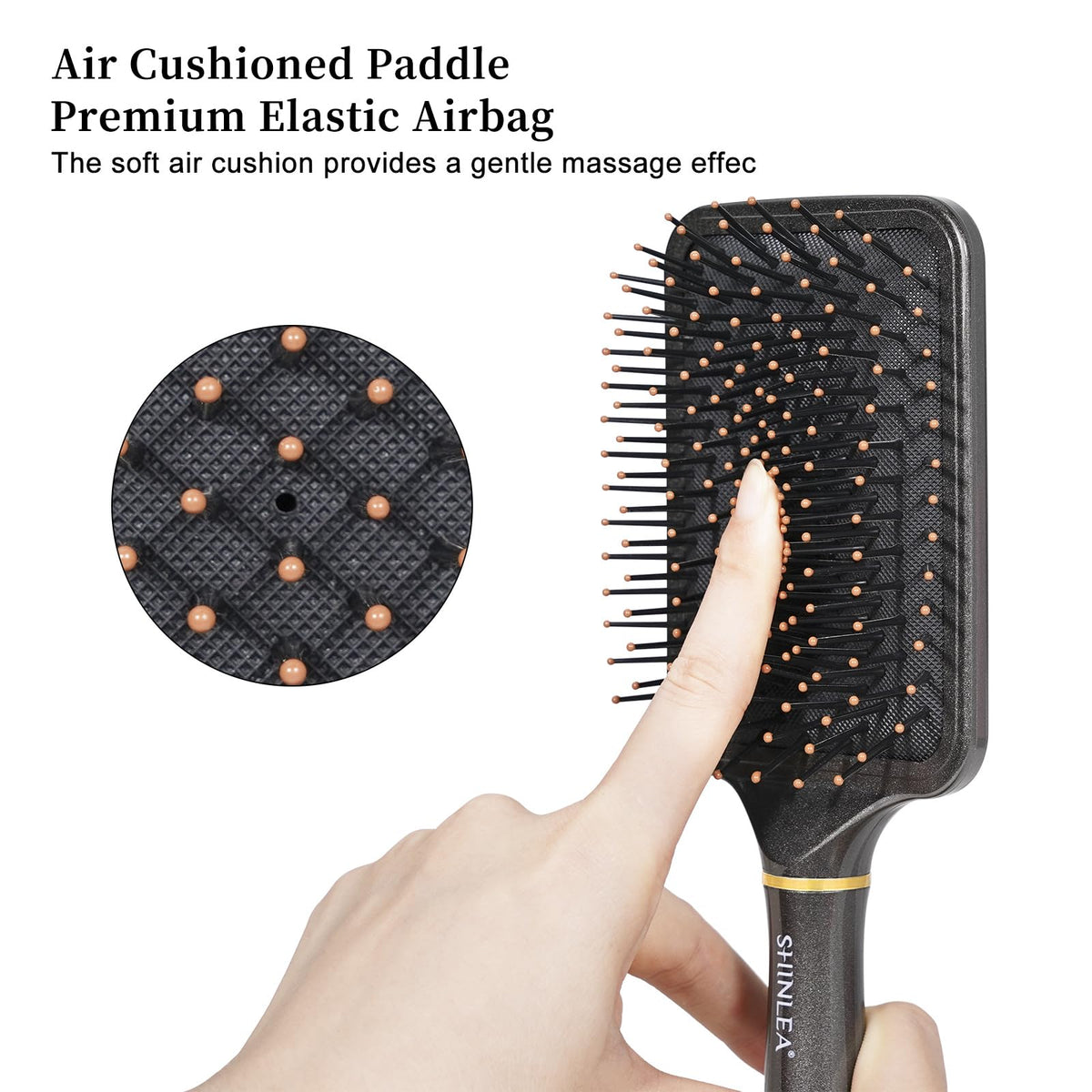 SHINLEA Detangling Brush in hand demonstrating ergonomic handle