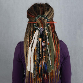Side view of the dreadlock hair tie with a focus on the yarn and shells