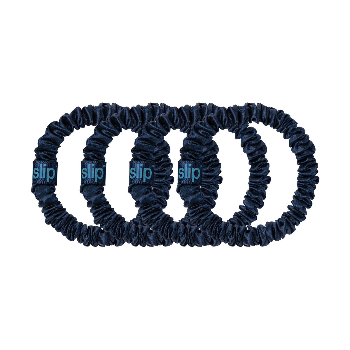 SLIP navy scrunchies displayed on a vanity