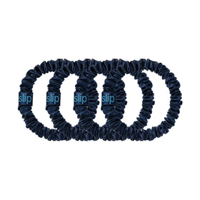 SLIP navy scrunchies displayed on a vanity