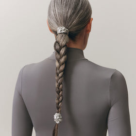 SLIP Silk Skinny Scrunchies in silver on a flat surface