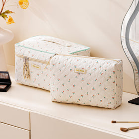 Small HBselect makeup bag with floral pattern on a vanity
