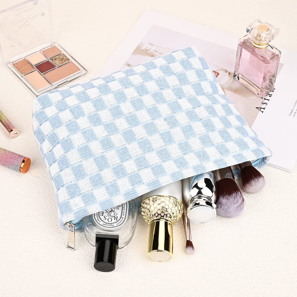 SOIDRAM blue checkered makeup bag in travel setting
