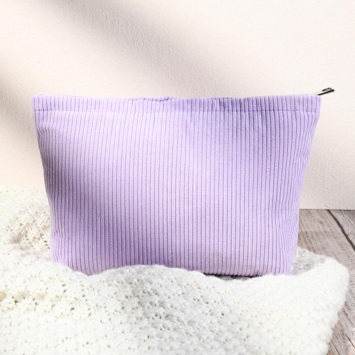 SOIDRAM cosmetic bags stacked together in purple