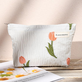 SOIDRAM floral makeup bag arranged on a vanity with cosmetics