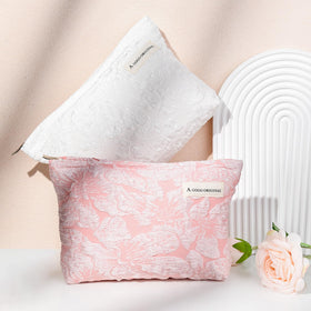 SOIDRAM Flower Makeup Bag Set on a travel suitcase