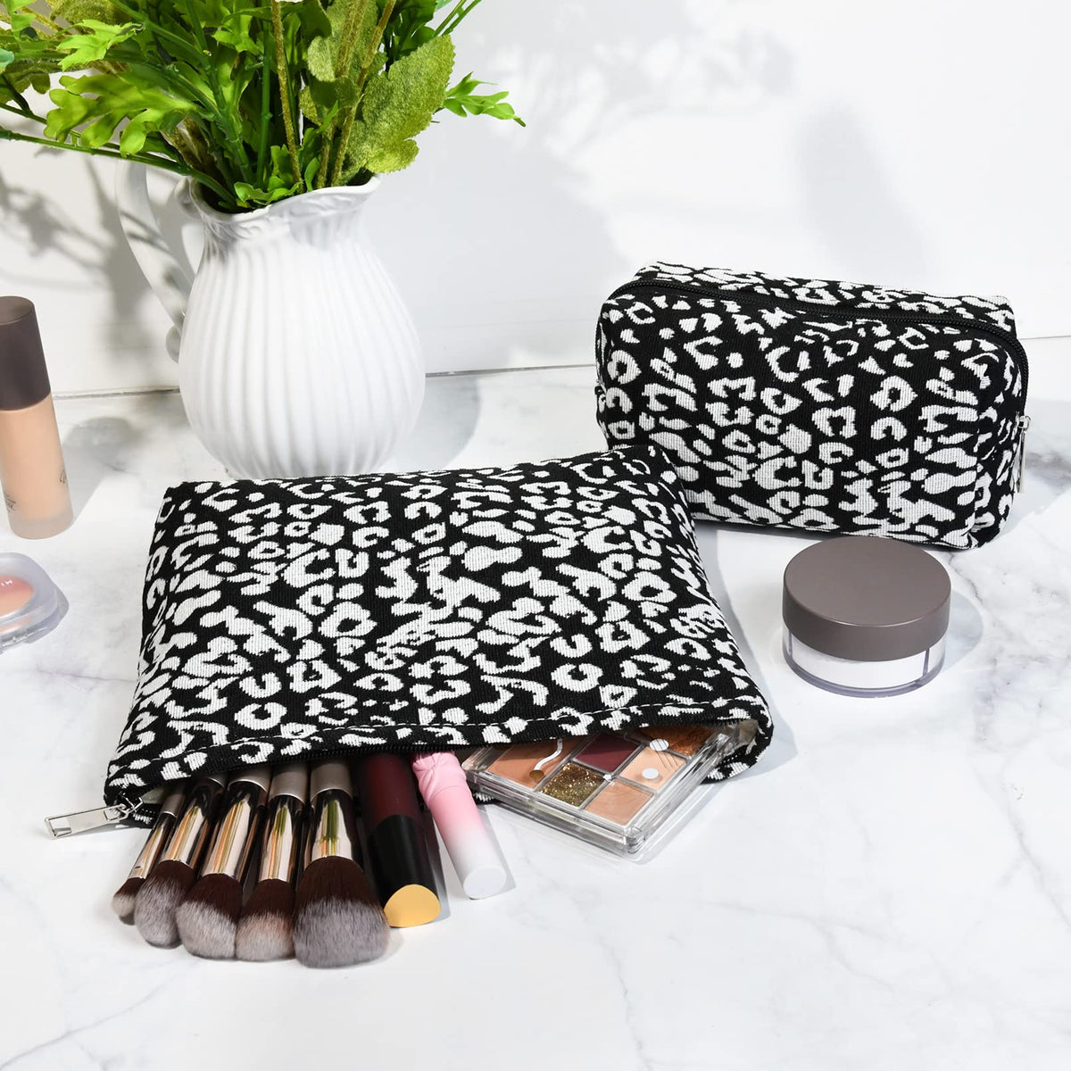 SOIDRAM Leopard Print Makeup Bag set on a travel suitcase