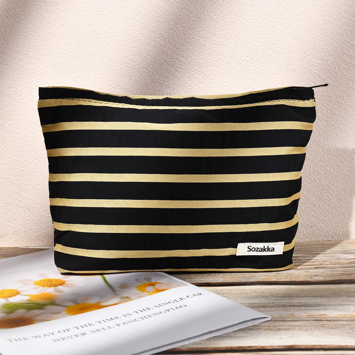 SOIDRAM makeup bag in black and white stripes on a table