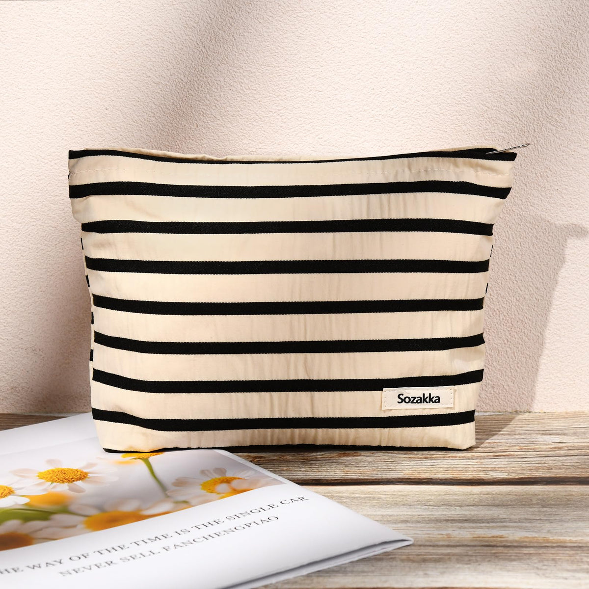 SOIDRAM makeup bags in a lifestyle setting with travel items