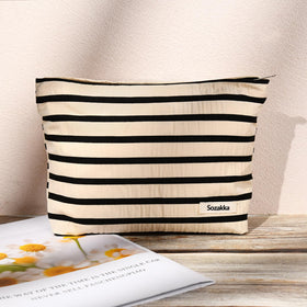 SOIDRAM makeup bags in a lifestyle setting with travel items