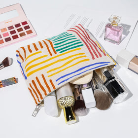 SOIDRAM makeup bags in various colors arranged neatly