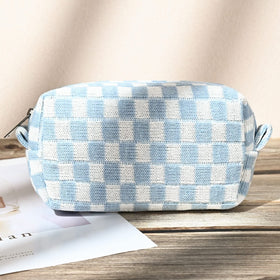 SOIDRAM makeup bags stacked with toiletries