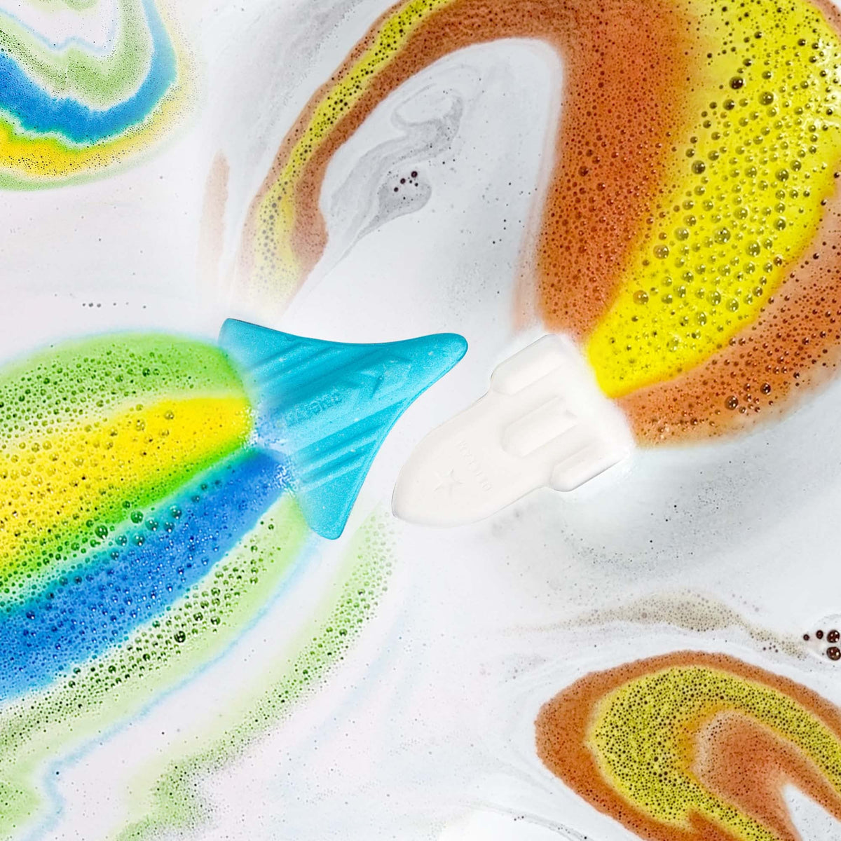 Space shuttle bath bomb fizzing in water with blue foam