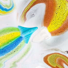 Space shuttle bath bomb fizzing in water with blue foam
