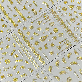 SPLOCUDU gold nail stickers in various patterns including flowers and stars