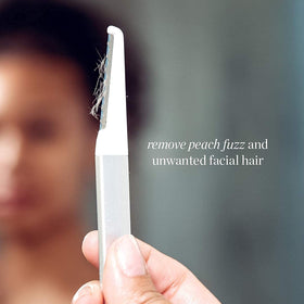 StackedSkincare Dermaplaning tool next to replacement blades