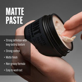 STMNT Matte Paste 3.38 oz showing texture on fingers